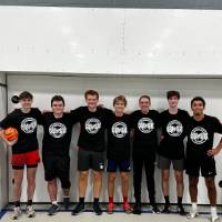Students wearing championship shirts from a futsal tournament